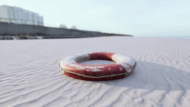 Lifebuoy on the city beach at sunset photo