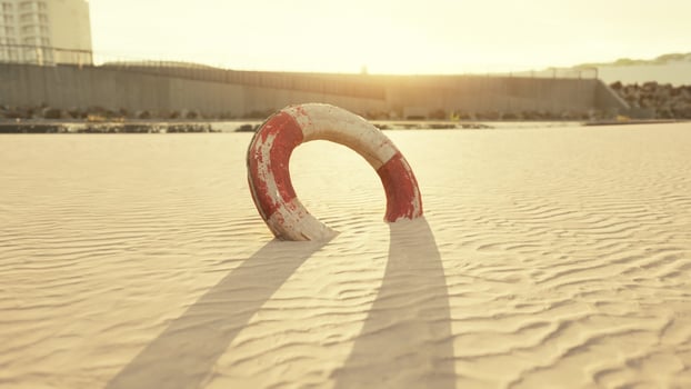 Lifebuoy on the city beach at sunset photo