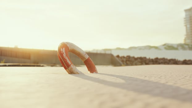 Lifebuoy on the city beach at sunset photo