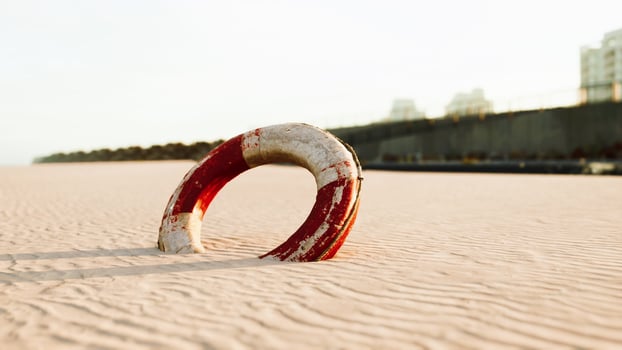 Lifebuoy on the city beach at sunset photo