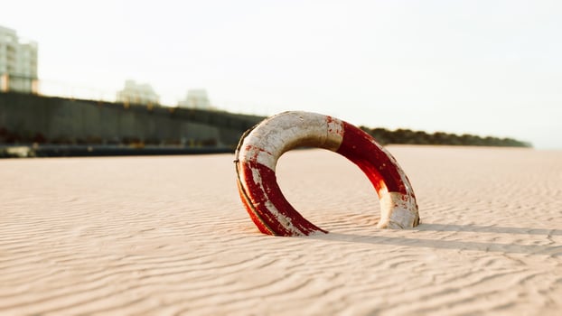 Lifebuoy on the city beach at sunset photo