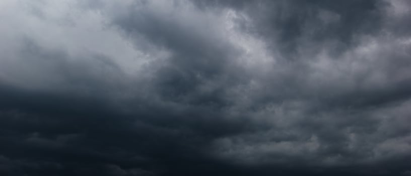 Bad or night weather sky and environment.The dark sky with heavy clouds converging and a hurricane storm before the rain. carbon dioxide emissions, greenhouse effect, global warming, climate change photo
