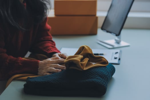 Startup SME small business entrepreneur of freelance Asian woman using a laptop with box Cheerful success Asian woman her hand lifts up online marketing packaging box and delivery SME idea concept photo