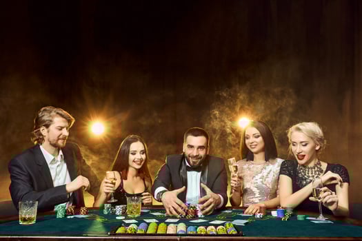 Poker players sitting around a table at a casino. photo