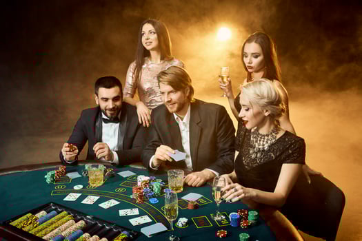 Poker players sitting around a table at a casino. photo