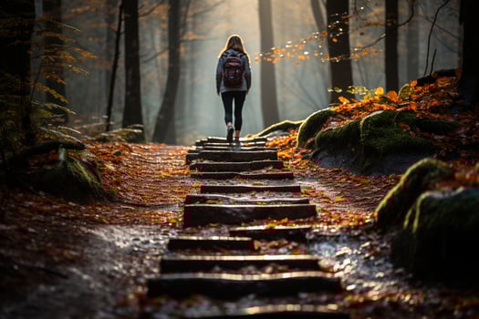 AI generated Girl sits cross-legged on moss-covered rock surrounded by tall trees, practices meditation as morning sun filters through foliage photo