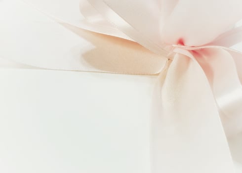 A pink ribbon isolated on a white background. Pink curly ribbon. Empty space for design. Romantic background image photo