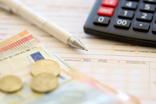 Filling italian tax form process with pen, calculator and euro money bills close up. Tax paying period photo
