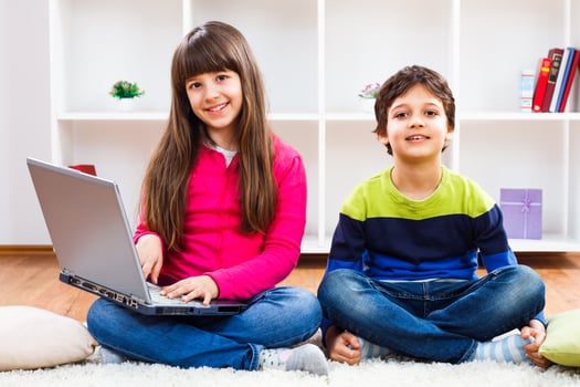 Two children using laptop photo