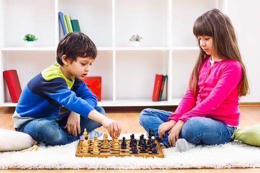 Two children playing chess photo