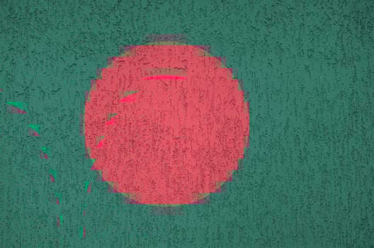 Bangladesh flag depicted in bright paint colors on old relief plastering wall. Textured banner on rough background photo