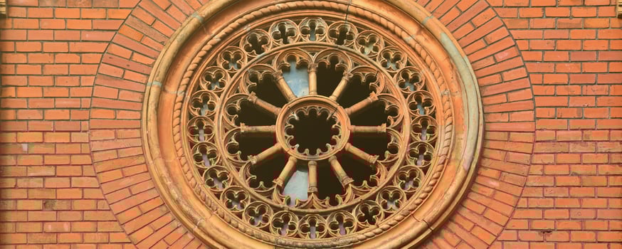 Texture front part of an ancient brick crypt with a round patterned carved window in the cemetery photo