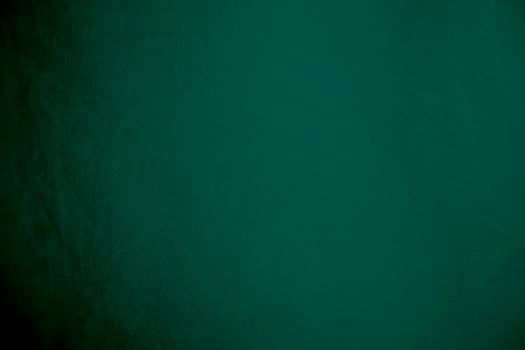Green velvet fabric texture used as background. Emerald color panne fabric background of soft and smooth textile material. crushed velvet .luxury emerald tone for silk.. photo