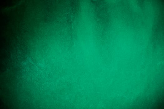 Green velvet fabric texture used as background. Emerald color panne fabric background of soft and smooth textile material. crushed velvet .luxury emerald tone for silk.. photo