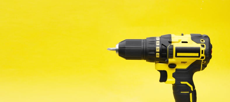The yellow-black screwdriver on a yellow background. photo