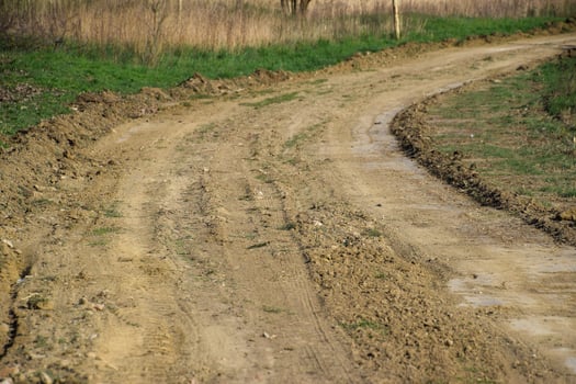 Dirt road leveled by a grader. Road in village photo