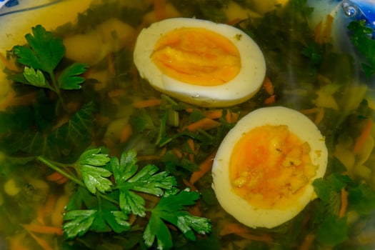 Soup with boiled egg and parsley photo