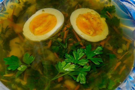 Soup with boiled egg and parsley photo