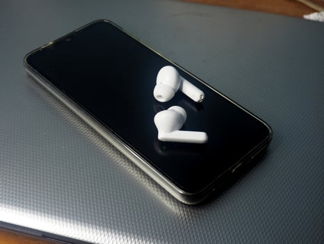 white earbuds and smart phone connect together photo