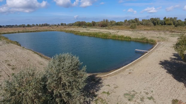 An artificial lake for fishing. A bridge for fishermen on the lake. Lake fishing. photo