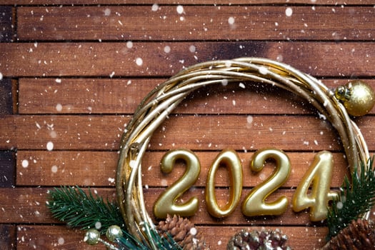 Happy New Year wooden numbers 2024 on cozy festive brown wooden background with sequins, snow, lights of garlands. Greetings, postcard. Calendar, cover photo