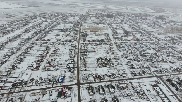 Top view of a winter village. The rural settlement is covered with snow. Snow and winter in the village photo