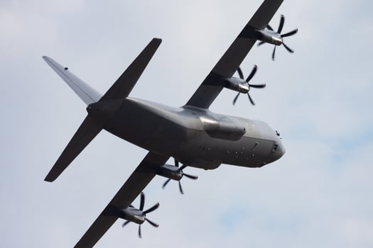 Untitled military transport plane at air base. Airport and airfield. Air force and army flight operation. Aviation and aircraft. Air lift. Military industry. Fly and flying. photo