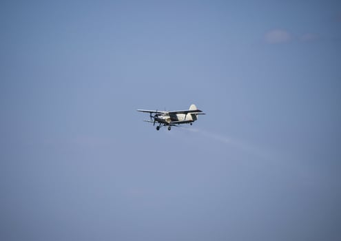 The spraying of fertilizers and pesticides on the field with the photo