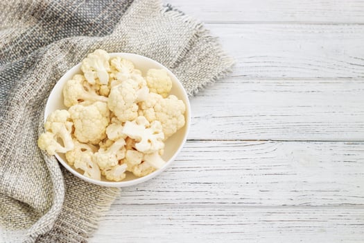 Cauliflower vegetables standing on a white wooden table photo