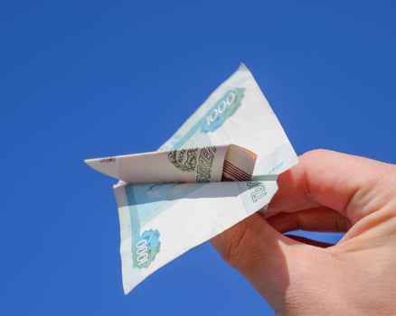 Denominations of Russian money, folded in the airplane against t photo