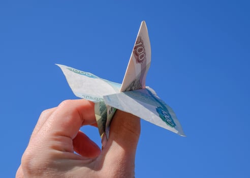 Denominations of Russian money, folded in the airplane against t photo