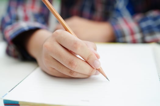 Asian teenage student write homework, study lesson for exam online learning education. photo