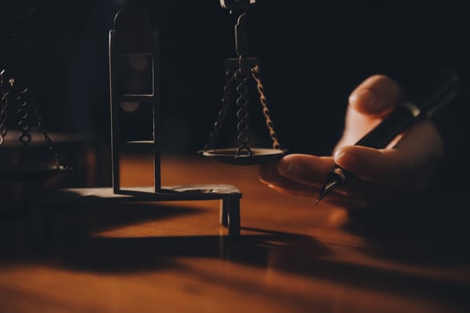 Business and lawyers discussing contract papers with brass scale on desk in office. Law, legal services, advice, justice and law concept picture with film grain effect photo