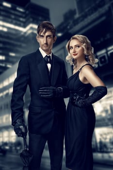 Man and woman secret agents and spies. Film noir. Retro style fashion portraits against the backdrop of the night city. Vintage Hollywood style. photo