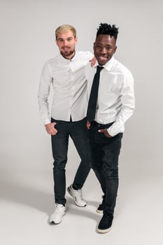 International friendship concept. Studio shot of two stylish young men on white background photo