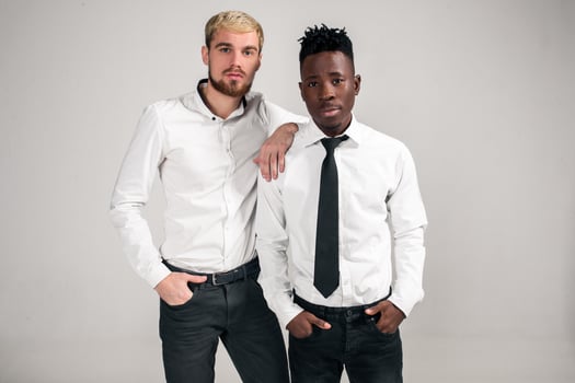 Two stylish men posing and having fun on white background. photo