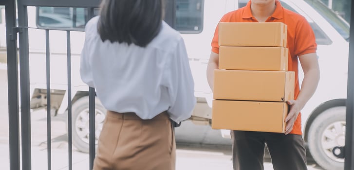 Asian Woman Receiving Product from delivery man at Home, Young Owner Woman Order Product from Smartphone Application, Woman with Online Business or SME Concept. photo
