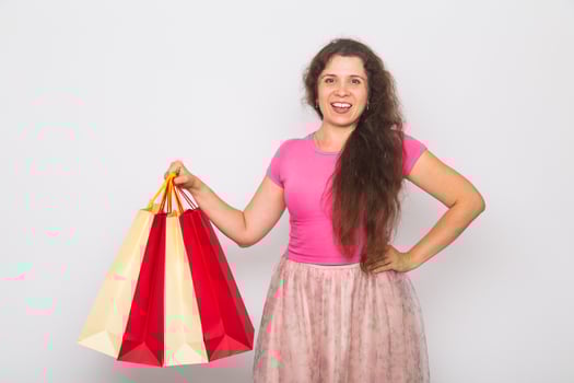 Portrait of young happy smiling woman with shopping bags, over white background. Purchase, sale and people concept photo