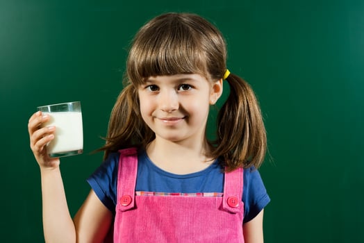 Little girl with glass of milk photo