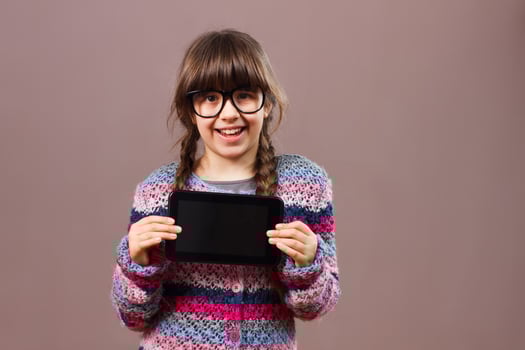 Little nerdy girl holding digital tablet photo