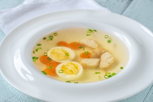 Chicken broth in plate photo