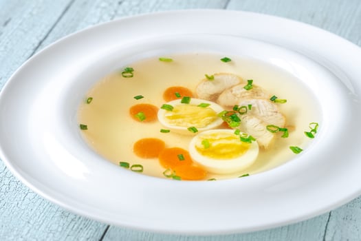 Chicken broth in plate photo