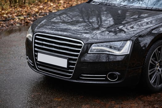 Modern black car driving on the road,  city car background photo