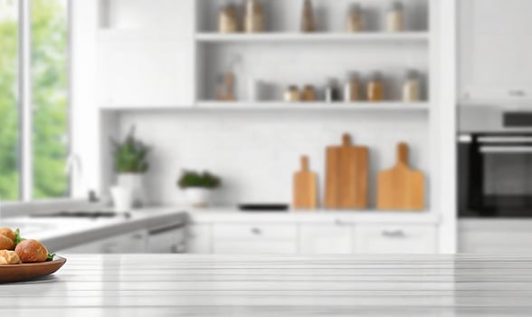Blurred view of modern kitchen with white furniture with wooden table photo