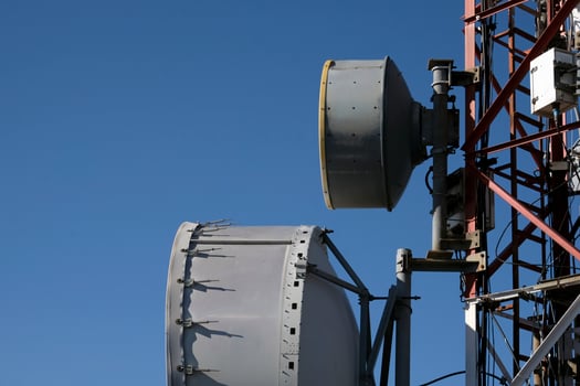 Telecommunication antenna with multiple satellite against the blue sky photo