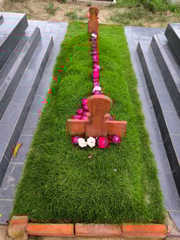 Muslim graves in Indonesia are decorated with manila grass plants and flowers photo