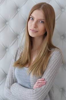 Beauty portrait. Young woman on grey wall background. photo
