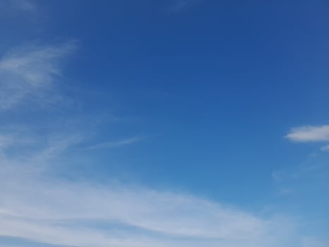 Beautiful white clouds on deep blue sky background. Large bright soft fluffy clouds are cover the entire blue sky. Skyscape on Lombok Island, Indonesia photo