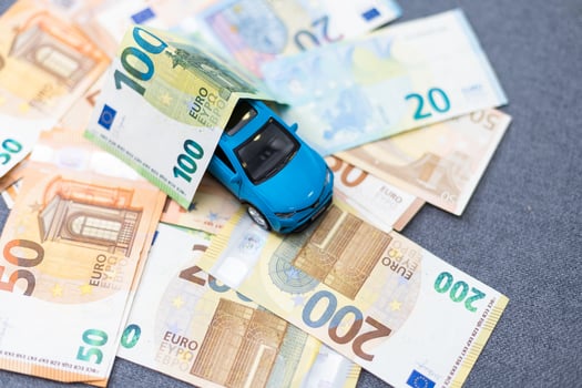 Toy car and euro on white photo