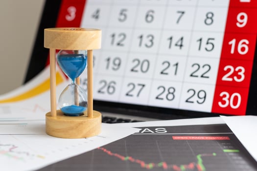 Hour glass and calendar concept for time slipping away for important appointment date, schedule and deadline photo